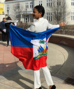 Myrdel Geffrard, orginally from Port-au-Prince, Haiti, holding out the flag of her home country.