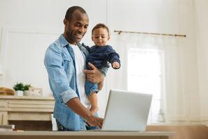 Saint Rose MBA student working from Home, pictured with their child