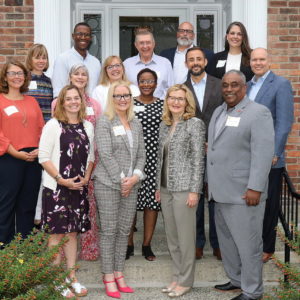 Group of enrollment management leaders posed outside of Saint Rose President's House