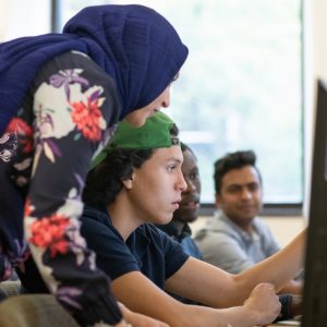 two people looking at a computer