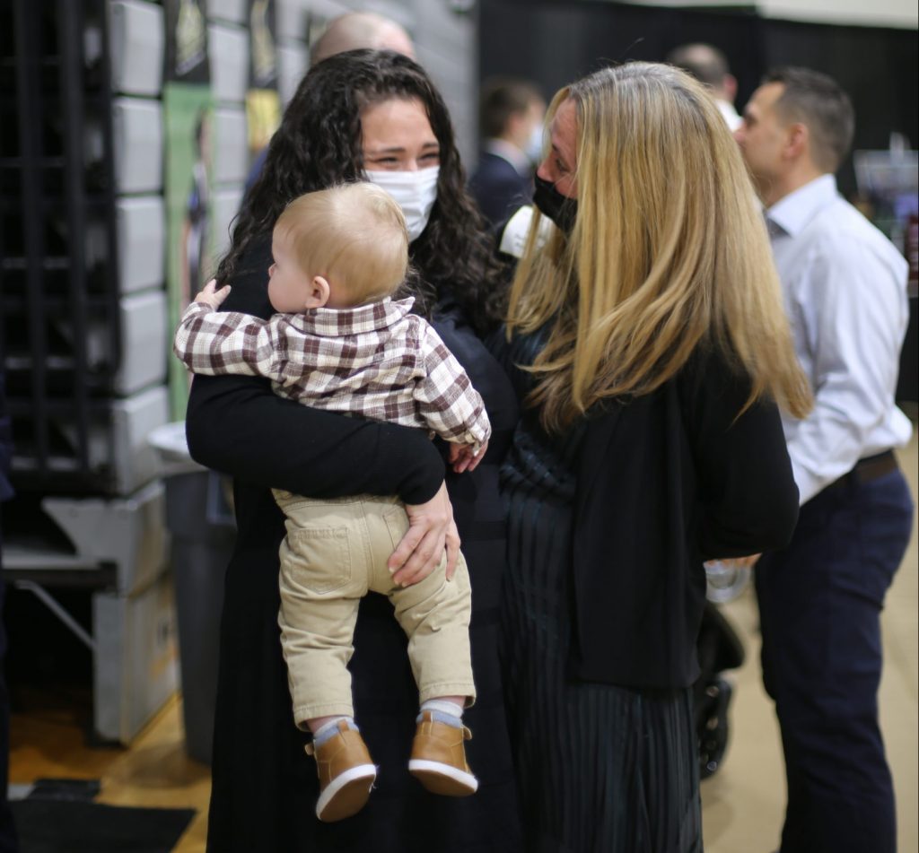 Saint Rose women's soccer coach Laurie Darling Gutheil with one of her former players and her baby