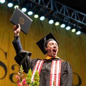 Grads cross the stage at the 2022 Saint Rose commencement ceremony.